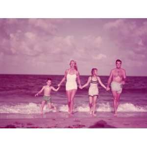  Family of Four Holding Hands, Walking Along Ocean Surf on 