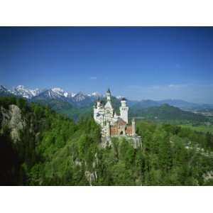  Neuschwanstein Castle on a Wooded Hill with Mountains in 