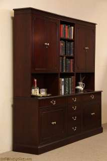 An executive credenza with bookcase or hutch top is signed by premier 