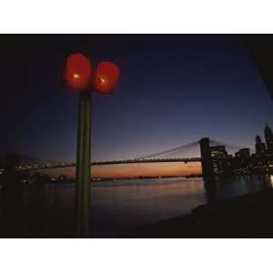  A Sunset View of the Brooklyn Bridge and a Nearby Stoplight 