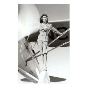  Stewardess Balancing on Plane Wheel Premium Poster Print 