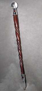 This powerful wand is polished of smooth swirling Rosewood, adorned 