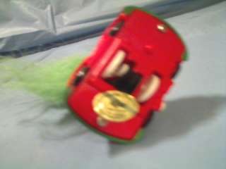 This RUSS TROLL DOLL WITH CHRISTMAS CAP HAT IN RED & GREEN WIND UP CAR 